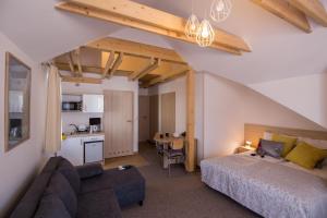 a bedroom with a bed and a kitchen with a table at Villa 1 in Wisła