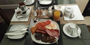 a plate of breakfast food on a table at 29 Well Street B&B in Moffat +19 photos