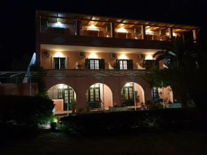 a night view of a building with lights at Marianna House in Agios Georgios Pagon +52 photos