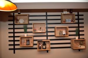 a wall with wooden shelves and pictures on it at Apartman Sladjana Premier 12 Milmari in Kopaonik