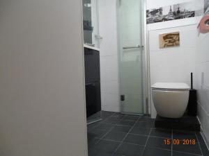 a bathroom with a toilet and a glass shower at Palm beach Cannes Azur in Cannes