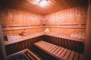 a sauna with wooden walls and benches in it at Villa Soula in Anavissos