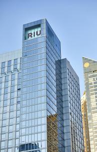 a tall glass building with the rut sign on it at Riu Plaza New York Times Square in New York