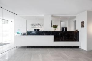 a lobby with a white reception desk in a building at Mantra Coolangatta Beach in Gold Coast