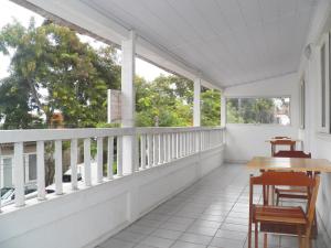 an empty porch with a table and chairs on it at Nascimento Suites in Búzios
