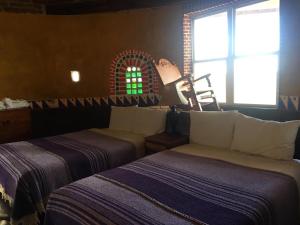 Una cama o camas en una habitación de Rancho Cabañas San Isidro