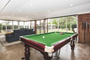 a living room with a pool table at Eurunderee House in Eurunderee
