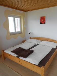 drewnianym łóżkiem w pokoju z oknem w obiekcie Haus Moni w mieście Mauterndorf