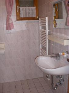a bathroom with a white sink and a mirror at Ferienwohnungen Winter in Lohberg
