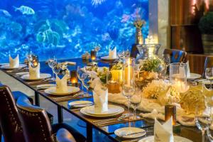 a long table with candles and glasses on it at Amaranta Hotel in Bangkok