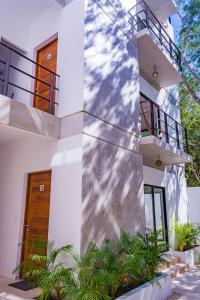 a white house with a staircase and plants at Mi Tulum in Tulum