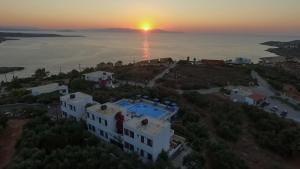 an aerial view of a house with the sunset in the background at Villas Michalis in Chorafakia