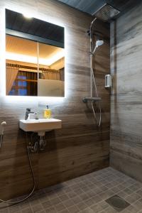 a bathroom with a sink and a mirror at De Gamlas Hem Hotel & Restaurant in Oulu