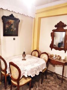 a dining room with a table and chairs at Xista Manor House ® in Pyrgi