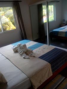 En eller flere senge i et værelse på Corner Bay Apartments Beau Vallon,Mahe