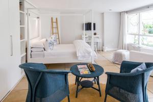 a living room with blue chairs and a couch at Lexden Guesthouse in Pietermaritzburg