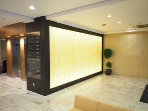 a large screen in the lobby of a building at Sky Heart Hotel Hakata in Fukuoka