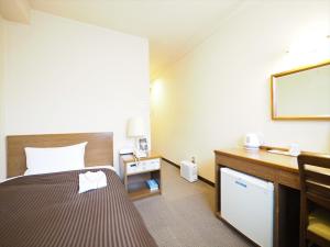 Кровать или кровати в номере Sky Heart Hotel Hakata
