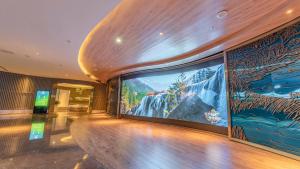 a large projection screen on the wall of a building at Chengdu Jiuzhaigou Hotel in Chengdu