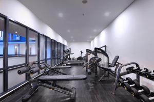 a gym with several treadmills and cardio machines at Harper Palembang by ASTON in Palembang