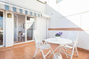 a white table and chairs on a balcony at Sagrada Familia Attic - Terrace Bcn Views in Barcelona