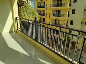 a balcony with a black railing in a building at Patnem Beach park in Canacona