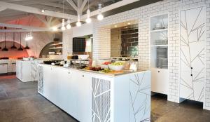 a kitchen with a counter with food on it at Ekies All Senses Resort, a Member of Design Hotels in Vourvourou
