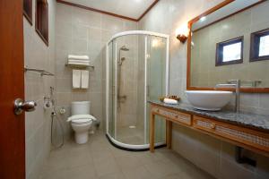 a bathroom with a toilet, sink, and shower at Sutera @ Mantanani Island Resort & Spa in Mantanani Island