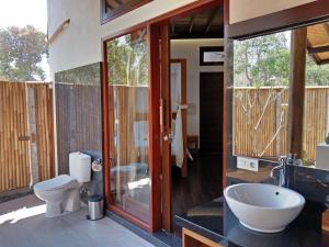 a bathroom with a toilet and a sink at Samari Hill Villa in Buleleng