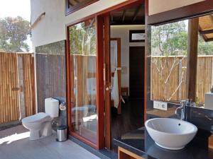 a bathroom with a toilet and a sink at Samari Hill Villa in Pabean Buleleng