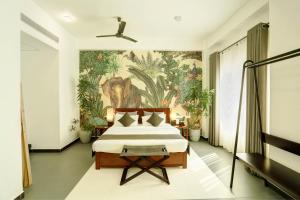 a bedroom with a bed with a painting on the wall at Morven Hotel Colombo in Colombo +44 photos