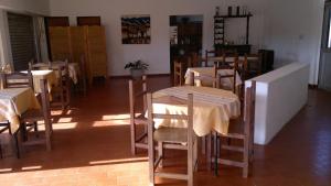 a group of tables and chairs in a restaurant at Hotel del Faro in Mar del Plata