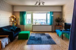 a living room with a couch and a window at Kouvola Apartment in Kouvola