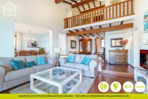a living room with a couch and a table at SolHabitat Villa Big Blue in Benissa