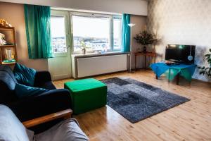 a living room with a couch and a large window at Kouvola Apartment in Kouvola