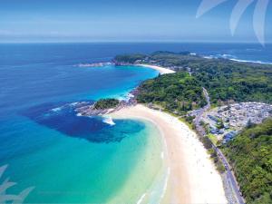 an aerial view of a beach and the ocean at Pippis a Classic Beach House in Seal Rocks