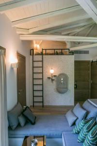 a living room with a couch and a bunk bed at Ekies All Senses Resort, a Member of Design Hotels in Vourvourou