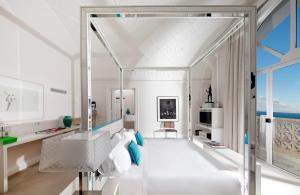 a white room with a white couch and a table at Bellevue Syrene in Sorrento