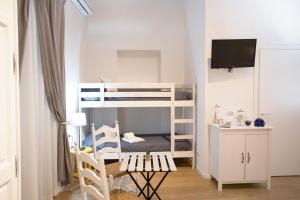 ナポリにあるQuartino Napoletanoの二段ベッド1組、デスクが備わる小さな客室です。