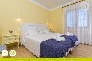 a bedroom with a large white bed and a window at Sol Habitat Villa La Sort in Moraira +50 photos
