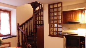 a kitchen with a spiral staircase in a room at La Casetta Di Vassena in Oliveto Lario