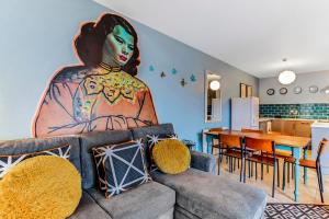 a living room with a large painting of a woman on the wall at Riverside Apartment in Derry Londonderry