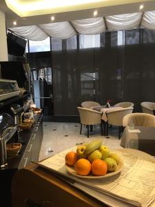 a plate of fruit on a table in a kitchen at Ambiance Hotel in Bucharest