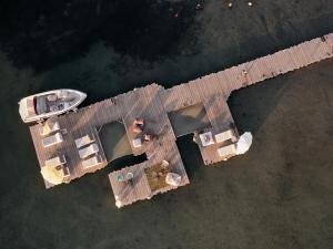 an overhead view of a wooden dock with a boat at Ekies All Senses Resort, a Member of Design Hotels in Vourvourou