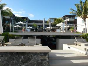 a group of chairs sitting on top of a building at Troux aux Biches Le Cerisier A2 Mauritius in Trou aux Biches