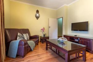 a living room with a couch and a table at Fallsway Apartments - Burley Court in Lusaka