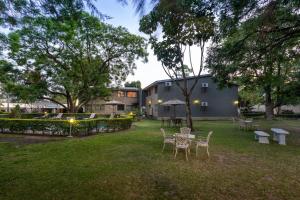 a yard with tables and chairs and a building at Fallsway Apartments - Louden Court in Lusaka