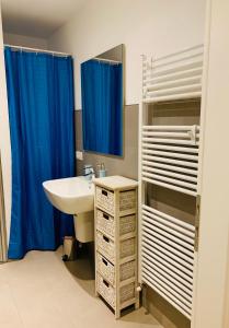 a bathroom with a sink and a mirror at Residenza Bouganville in Torri del Benaco