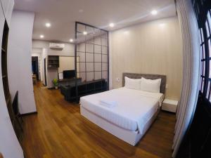 1 dormitorio con 1 cama blanca y sala de estar en Anna Hotel and Apartment, en Nha Trang