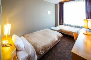 Postelja oz. postelje v sobi nastanitve Hotel Grand Vert Gizan
